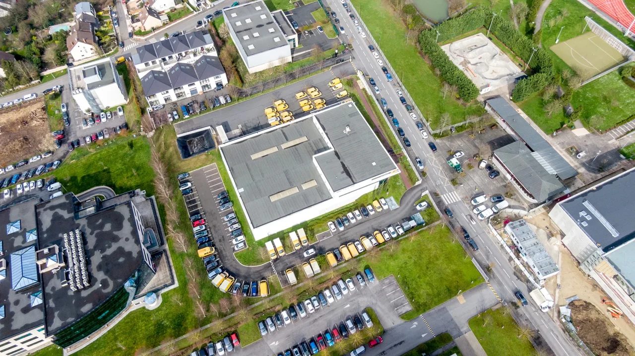 Vue aérienne du bâtiment logistique La Poste intégré dans un environnement urbain dense