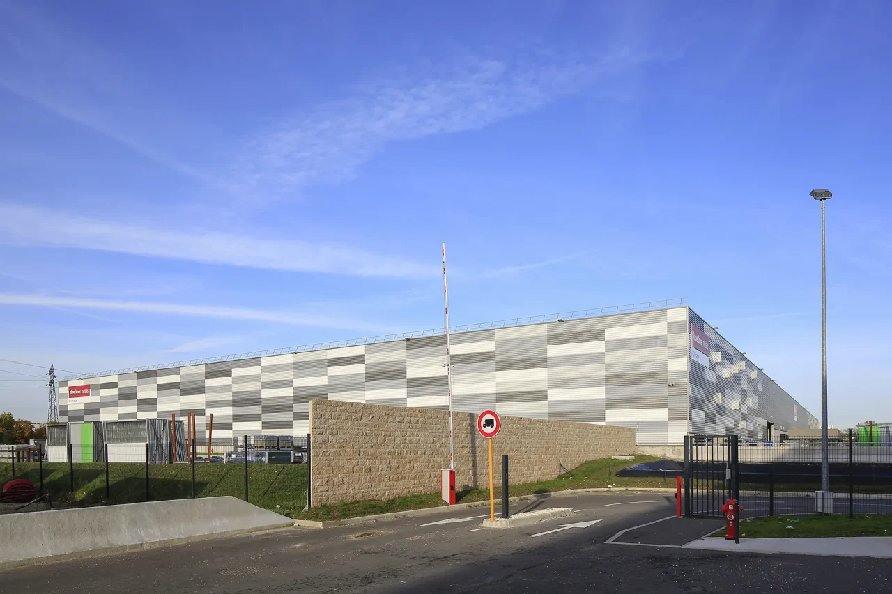 Entrée du site logistique KDI avec portail sécurisé et accès poids lourds à Neuville-sur-Oise